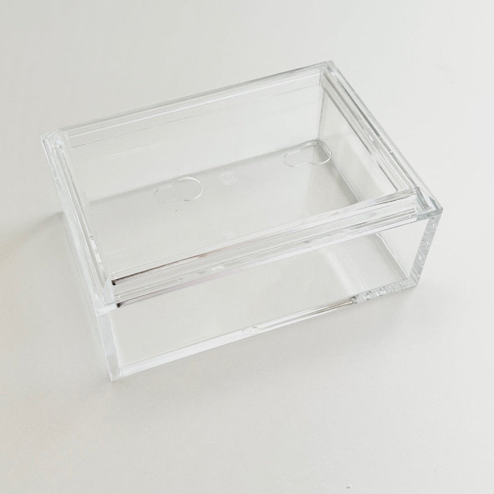 Clear acrylic box with photo lid on a white surface.