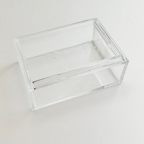 Clear acrylic box with photo lid on a white surface.