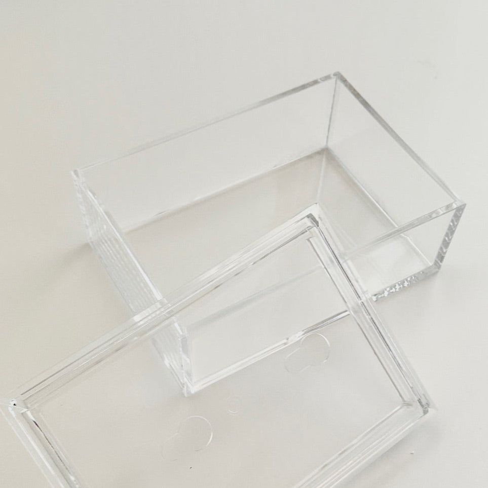 Clear acrylic rectangular box on a light surface.