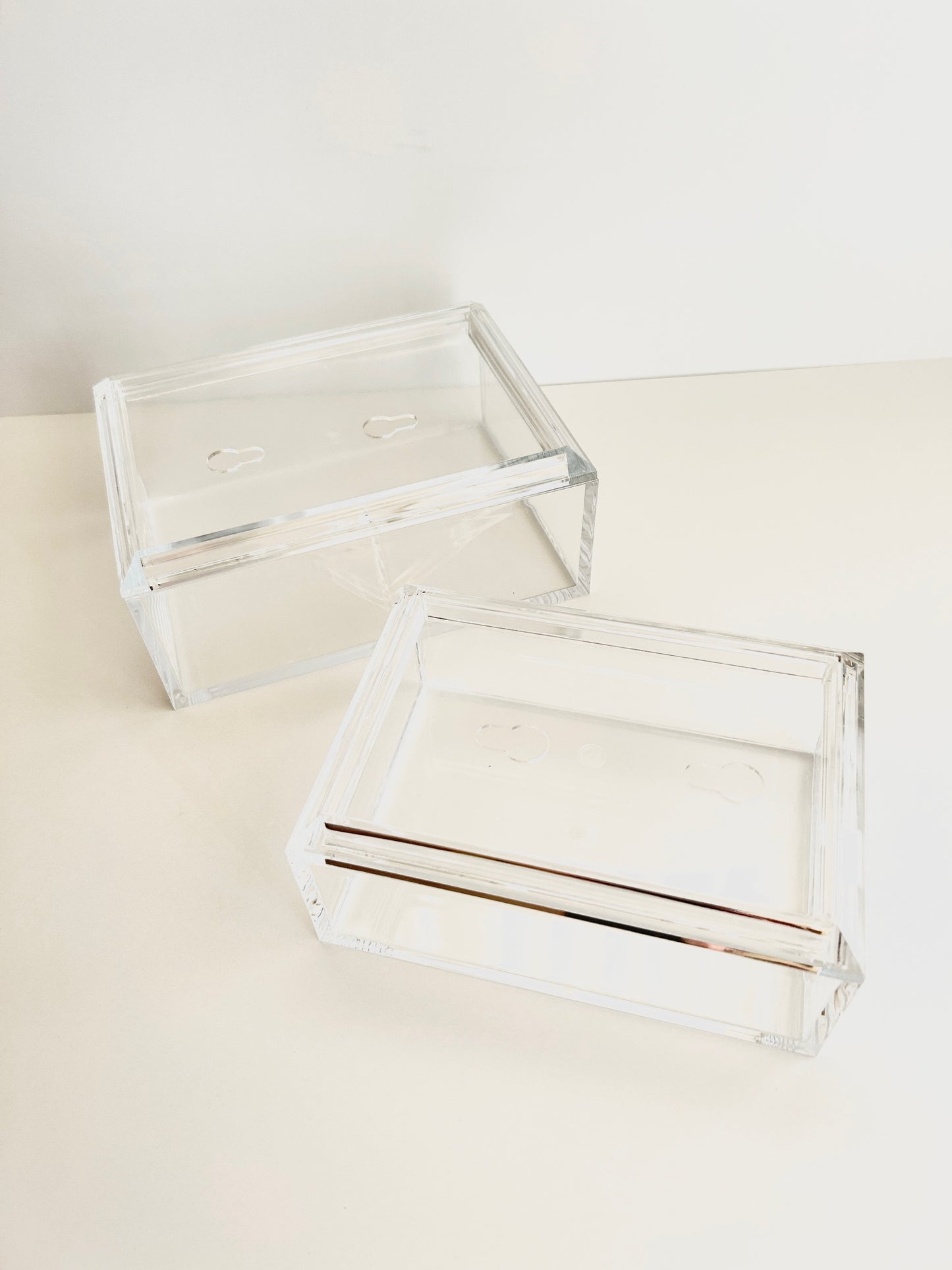 Two clear acrylic boxes for needlepoint with a white background