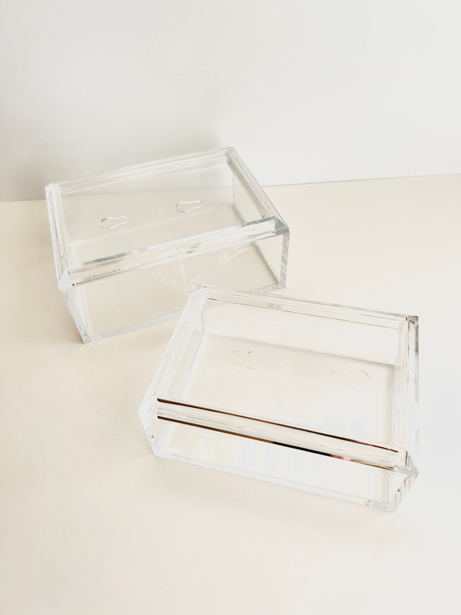 Two clear acrylic boxes for needlepoint with a white background