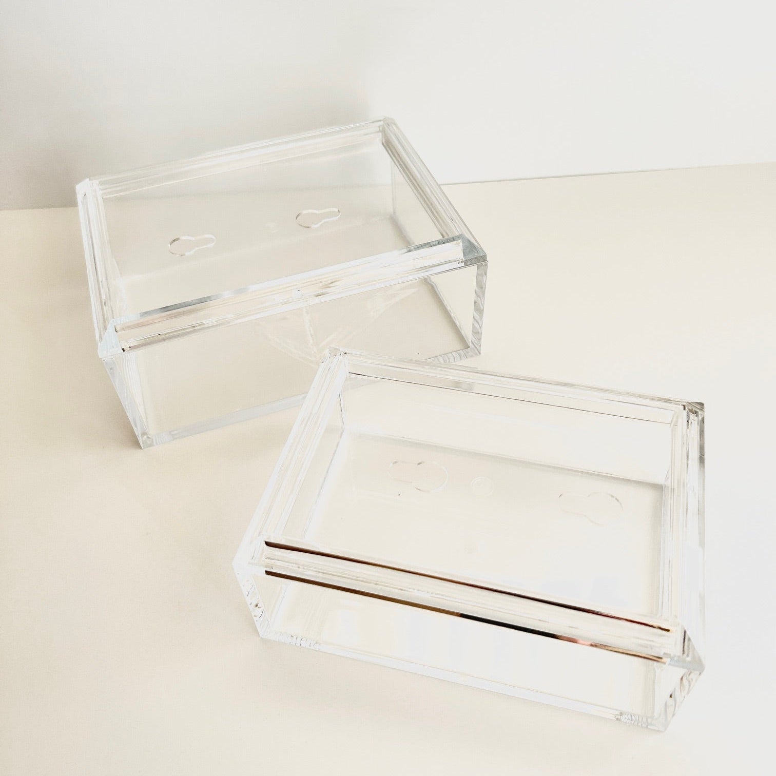 Two clear acrylic boxes for needlepoint with a white background