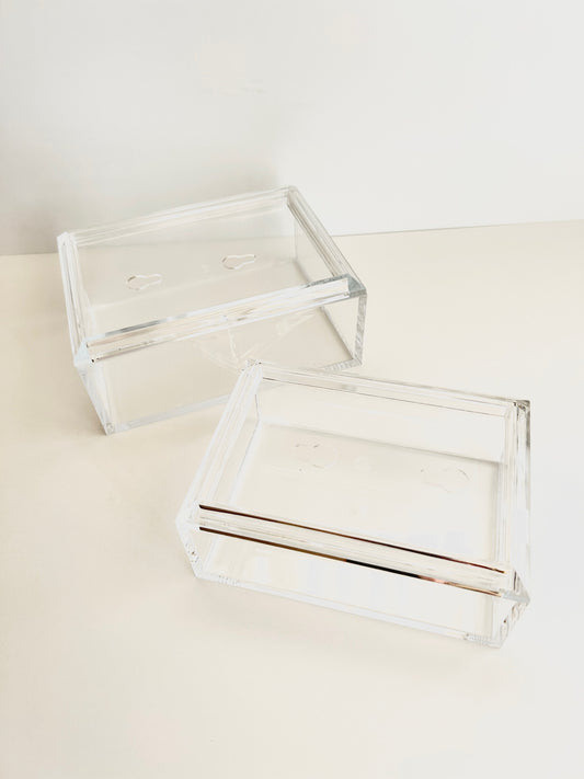 Two clear acrylic boxes for needlepoint with a white background