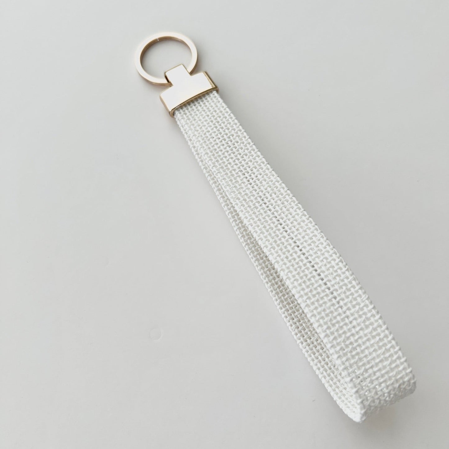 Blank keychain with gold hardware on a white background.
