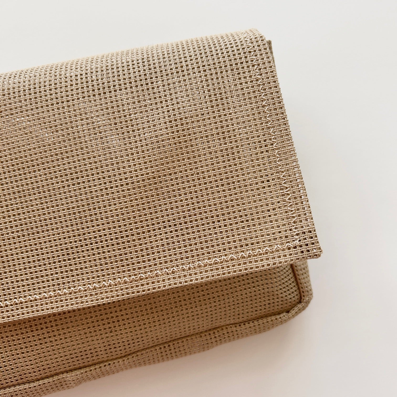 A blank fully stitchable needlepoint bag in penelope canvas.
