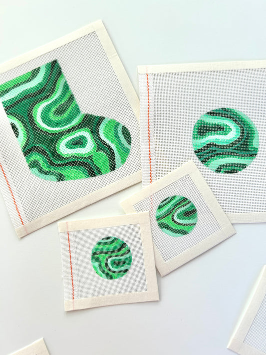 Malachite holiday collection of canvases showing the mini stocking, bag charms and ornament round.