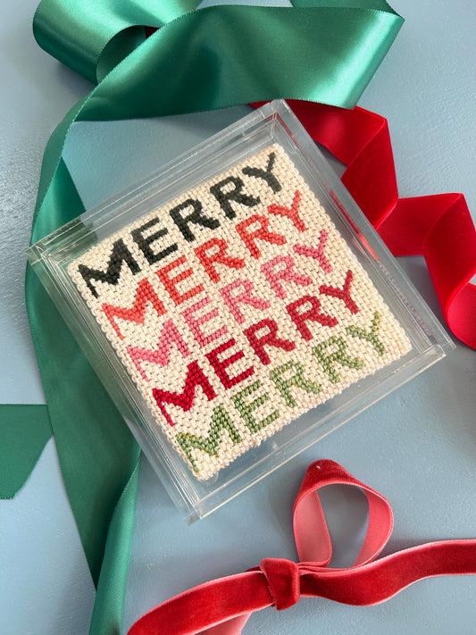 Image of Merry  Merry Needlepoint canvas in an acrylic coaster with holiday ribbons.