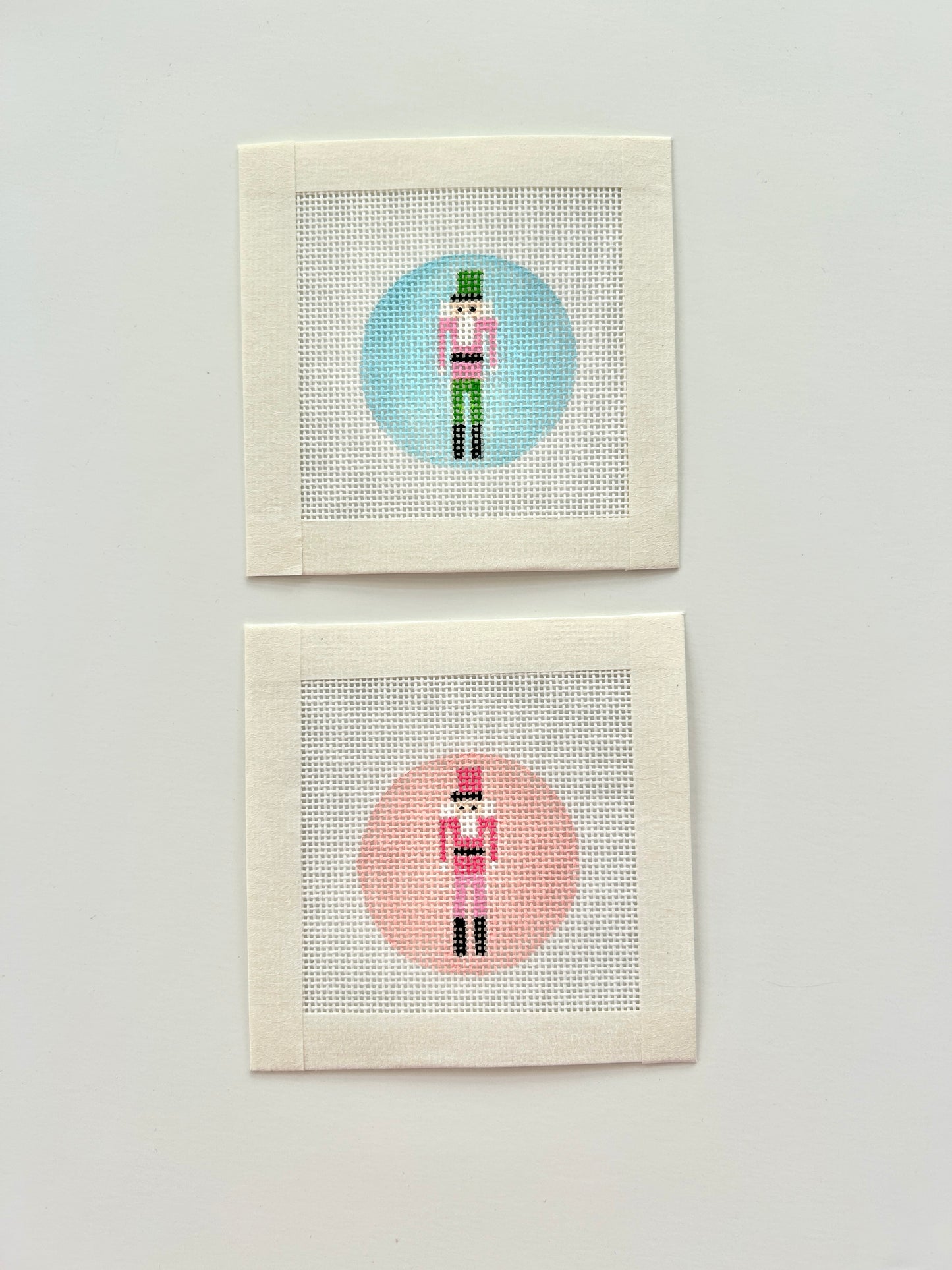 Mini nutcracker round bag charm canvases in pink nd blue.