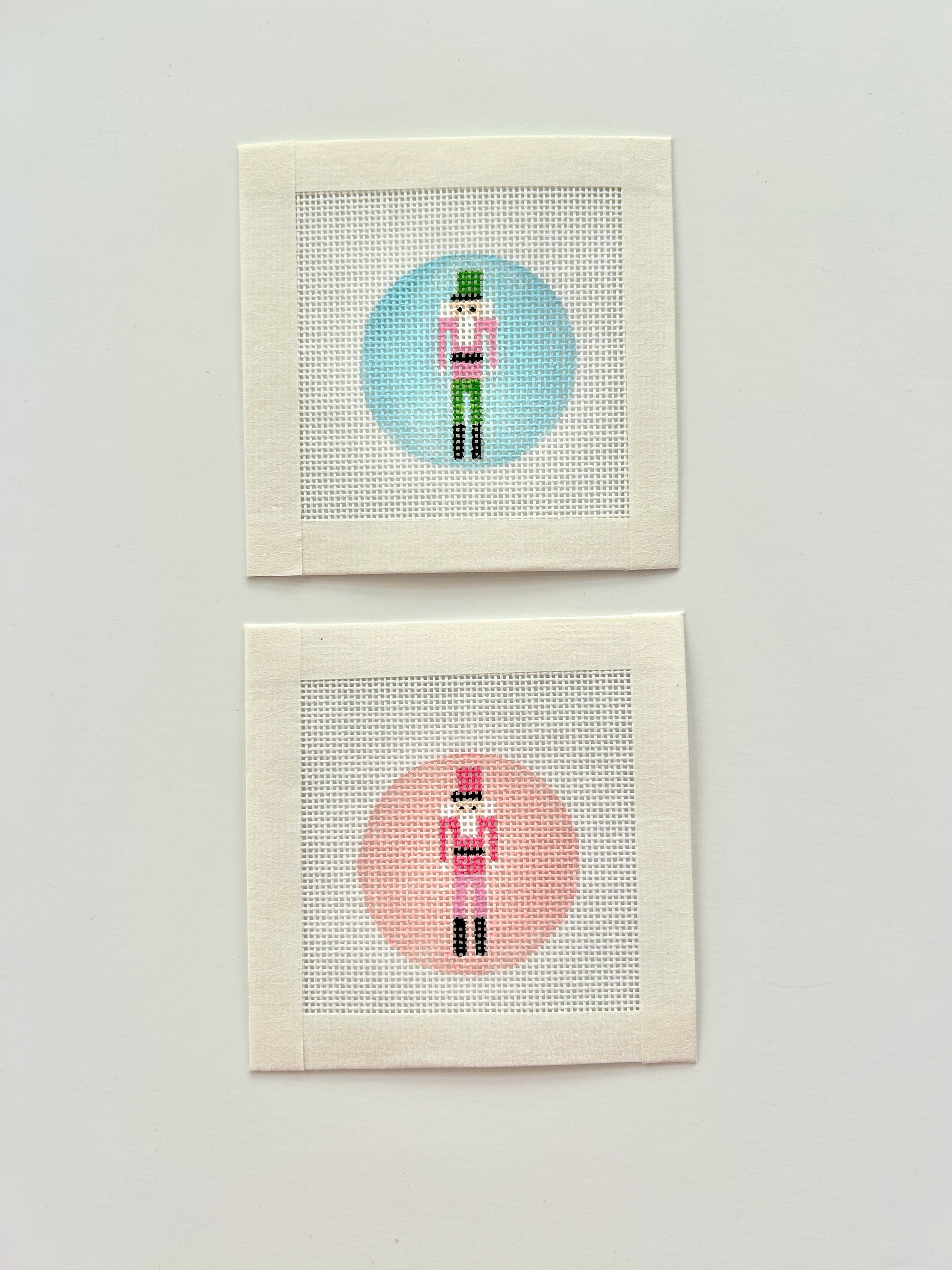 Mini nutcracker round bag charm canvases in pink nd blue.