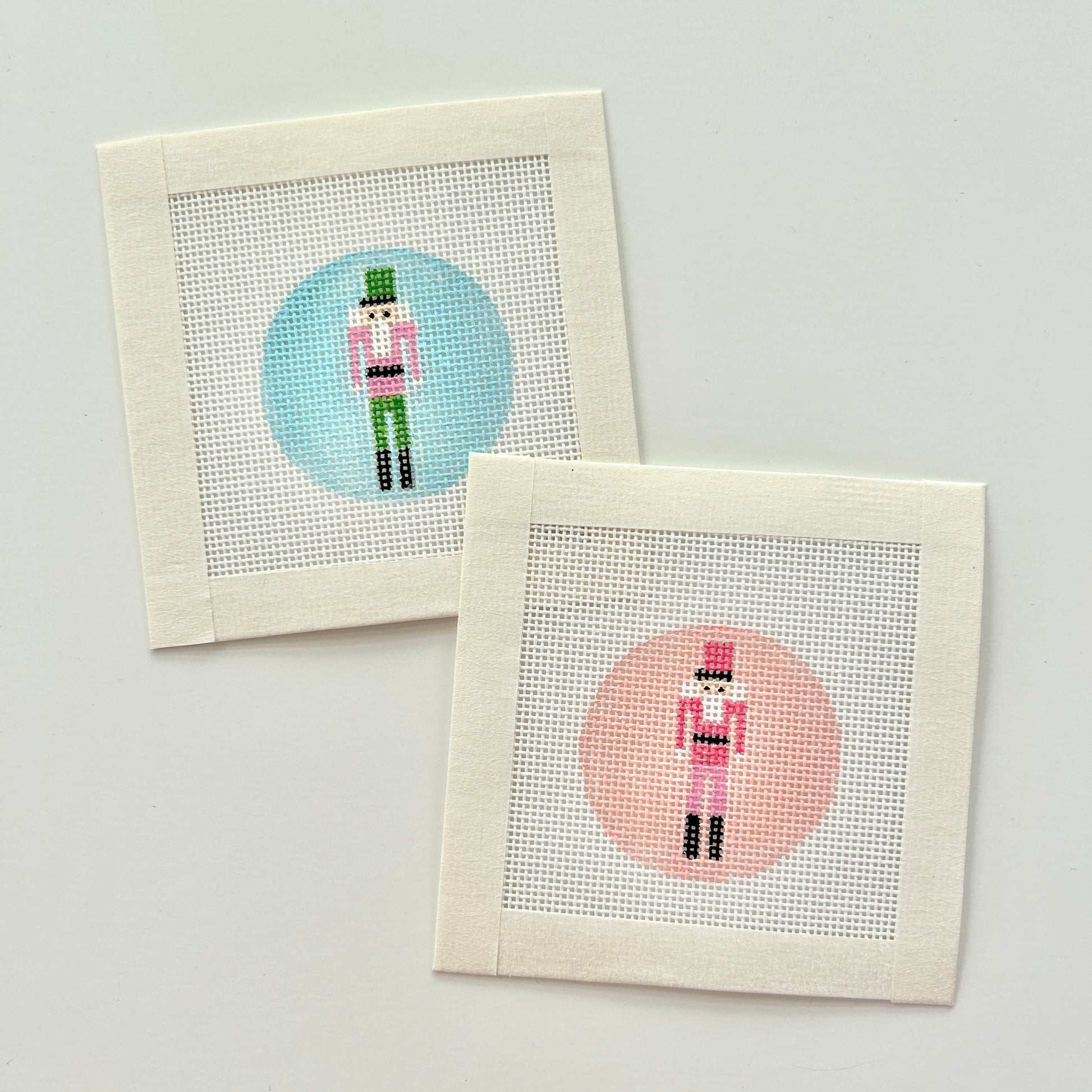 Mini nutcracker bag charm canvas in 18 mesh with pink or blue backgrounds.