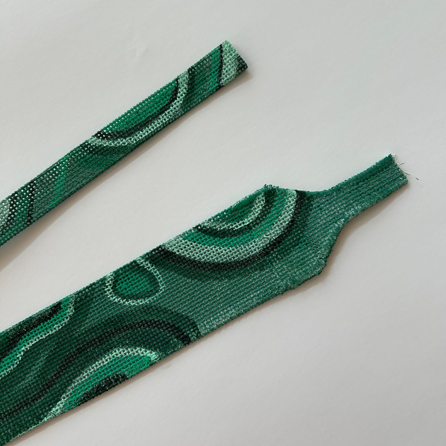 Comparison image of the different strap styles for the needlepoint bag.